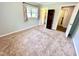 Bedroom features neutral carpet, light gray paint, and has access to the laundry room at 2101 S Roxboro St, Durham, NC 27707
