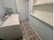 Laundry room features washer, dryer, patterned tile floors, and built in shelving at 2101 S Roxboro St, Durham, NC 27707