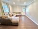 Large living room features a large sectional sofa, wood-look floors and natural light at 2101 S Roxboro St, Durham, NC 27707