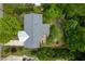 An aerial view of a well-maintained home with a deck, lush backyard, and mature trees at 2128 Watkins St, Raleigh, NC 27604