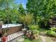Hot tub in a backyard with mature bamboo and palm trees surrounded by a lush green lawn at 2128 Watkins St, Raleigh, NC 27604