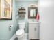 Neat powder room with simple decor, elegant sink, and floating shelving unit at 2128 Watkins St, Raleigh, NC 27604