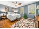 Inviting bedroom with hardwood floors, ceiling fan, and warm decorative lighting at 2128 Watkins St, Raleigh, NC 27604