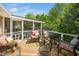 Inviting outdoor deck featuring wicker seating, colorful cushions, and views of the lush green landscape at 2128 Watkins St, Raleigh, NC 27604