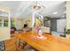 Bright dining area open to the living space, enhanced by hardwood floors and cheerful yellow walls at 2128 Watkins St, Raleigh, NC 27604