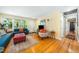 Inviting living room with hardwood floors, featuring ample seating and a view of the front yard at 2128 Watkins St, Raleigh, NC 27604