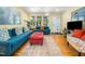 Spacious living room with hardwood floors, bright yellow walls, and plenty of natural light at 2128 Watkins St, Raleigh, NC 27604