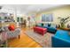 Bright living room featuring hardwood floors, with an open concept connecting to the dining area and kitchen at 2128 Watkins St, Raleigh, NC 27604