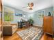 Home office with hardwood floors, ceiling fan, natural light, and comfortable furnishings at 2128 Watkins St, Raleigh, NC 27604