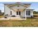 Inviting back patio with a ceiling fan, outdoor seating, and a grill for entertainment at 214 Thumper Way, Clayton, NC 27520