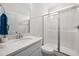 Modern bathroom features a white vanity, a quartz countertop and a glass enclosed shower at 214 Thumper Way, Clayton, NC 27520