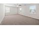 Large bedroom featuring carpet flooring, neutral paint, a ceiling fan, and lots of windows at 214 Thumper Way, Clayton, NC 27520