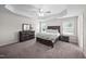 Spacious bedroom features a tray ceiling, ceiling fan, and dark wood furniture at 214 Thumper Way, Clayton, NC 27520