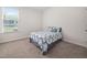 Carpeted bedroom features a window allowing for plenty of natural light at 214 Thumper Way, Clayton, NC 27520