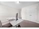 Bedroom with carpet flooring featuring a desk, chair, and a double door closet at 214 Thumper Way, Clayton, NC 27520