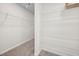This walk in closet has carpet flooring and shelving system for ample storage at 214 Thumper Way, Clayton, NC 27520