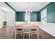 Elegant dining room with wainscoting, and wood table illuminated by chandelier, with large windows at 214 Thumper Way, Clayton, NC 27520