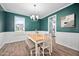 Bright dining room features modern lighting and a dining set that complements the hardwood flooring at 214 Thumper Way, Clayton, NC 27520