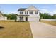 Charming two-story home with a well-manicured lawn and a welcoming front porch at 214 Thumper Way, Clayton, NC 27520