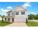 Charming two-story home features white siding, black shutters, covered porch, and attached two car garage at 214 Thumper Way, Clayton, NC 27520