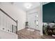 Bright foyer with hardwood floors, staircase, and views into other living spaces at 214 Thumper Way, Clayton, NC 27520