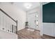 Bright foyer with hardwood floors, white walls, staircase, and front door with glass sidelights at 214 Thumper Way, Clayton, NC 27520