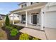 Inviting front porch featuring comfortable seating and complemented by lush landscaping at 214 Thumper Way, Clayton, NC 27520