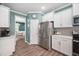 Spacious kitchen featuring stainless steel appliances, ample cabinet space, and modern finishes at 214 Thumper Way, Clayton, NC 27520