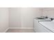 Featuring tile floors and a modern Samsung washer and dryer, this well-lit laundry room is move-in ready! at 214 Thumper Way, Clayton, NC 27520