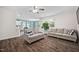 Spacious living room includes hardwood floors, ceiling fan, neutral paint, and access to the kitchen at 214 Thumper Way, Clayton, NC 27520