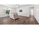 Comfortable living room boasts hardwood floors, access to the bathroom, and plenty of natural light at 214 Thumper Way, Clayton, NC 27520