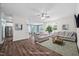 Spacious living room features two couches, hardwood floors, and lots of natural light from the windows at 214 Thumper Way, Clayton, NC 27520