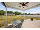 Covered patio with ceiling fan, lighting, and ample space for outdoor seating and entertaining at 214 Thumper Way, Clayton, NC 27520
