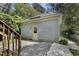 View of backyard showing the side door and concrete patio, as well as partial view of stairs at 2157 Dunn Rd, Raleigh, NC 27614