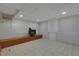 Finished basement area with tile flooring, wood burning stove, built-in cabinets, and drop ceiling with recessed lighting at 2157 Dunn Rd, Raleigh, NC 27614