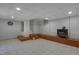 View of finished basement featuring a dartboard, tile flooring, wood burning stove, and staircase at 2157 Dunn Rd, Raleigh, NC 27614