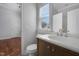 Bathroom featuring a vanity sink, toilet, and window with natural light at 2157 Dunn Rd, Raleigh, NC 27614