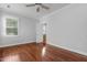 Bedroom with hardwood flooring, ceiling fan, and a bright view at 2157 Dunn Rd, Raleigh, NC 27614