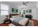 Staged main bedroom featuring warm lighting, hardwood floors and decor at 2157 Dunn Rd, Raleigh, NC 27614
