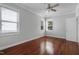 Light-filled bedroom with hardwood floors and dual windows with blinds at 2157 Dunn Rd, Raleigh, NC 27614