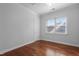 Bedroom featuring hardwood floors, natural light, and spacious closet at 2157 Dunn Rd, Raleigh, NC 27614