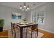 Dining area featuring a modern light fixture, hardwood floors, and plantation shutters at 2157 Dunn Rd, Raleigh, NC 27614