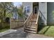 Home exterior featuring a wooden staircase leading to an elevated entryway and fenced in area at 2157 Dunn Rd, Raleigh, NC 27614