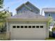 Detached garage with white garage door and view of the home's exterior at 2157 Dunn Rd, Raleigh, NC 27614