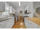 Modern kitchen with white cabinets, stainless steel appliances, and a subway tile backsplash at 2157 Dunn Rd, Raleigh, NC 27614