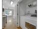 Laundry room with white washer and dryer, wire shelving, and adjacent to kitchen at 2157 Dunn Rd, Raleigh, NC 27614