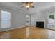 Living area with a fireplace, hardwood floors, and natural light from the windows at 2157 Dunn Rd, Raleigh, NC 27614