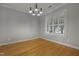 An empty living room featuring hardwood floors, recessed lights, and a large window at 2157 Dunn Rd, Raleigh, NC 27614