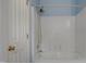 White tiled shower and tub featuring modern fixtures, and a shower head at 2157 Dunn Rd, Raleigh, NC 27614