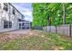 The backyard features a patio, a screened porch, and a fenced-in yard with mature trees at 217 Carolina Town Ln, Holly Springs, NC 27540